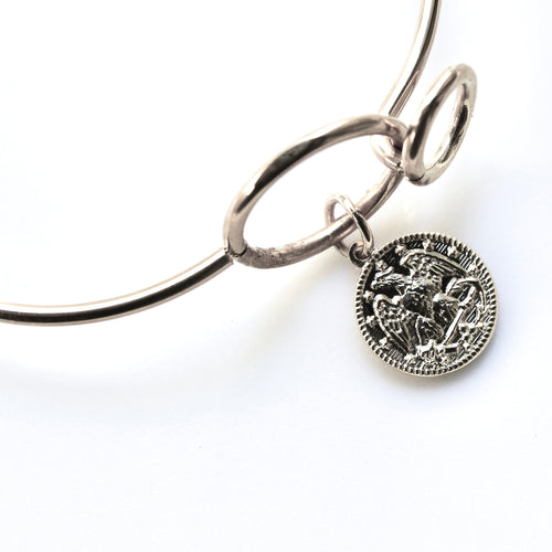 Silver bracelet with a detailed pendant on a white background
