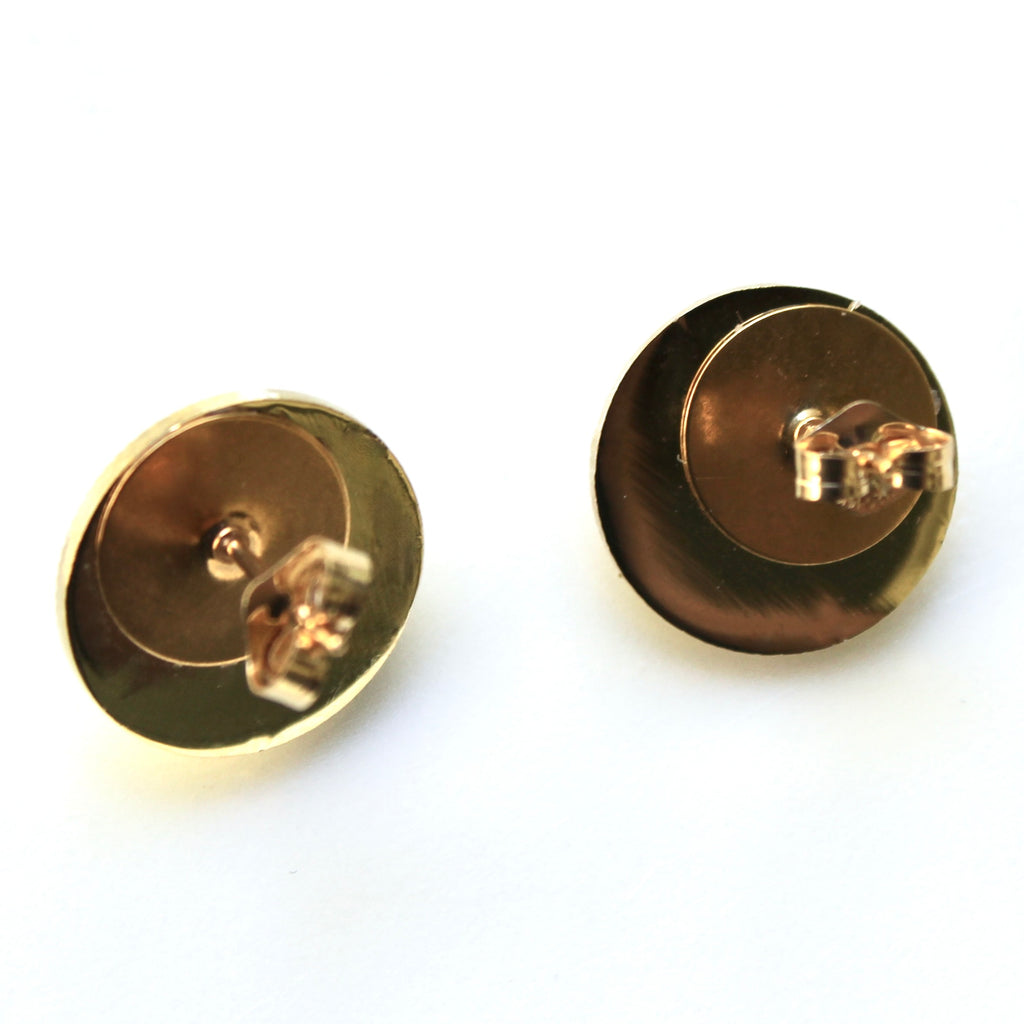 Pair of gold earrings on a white background