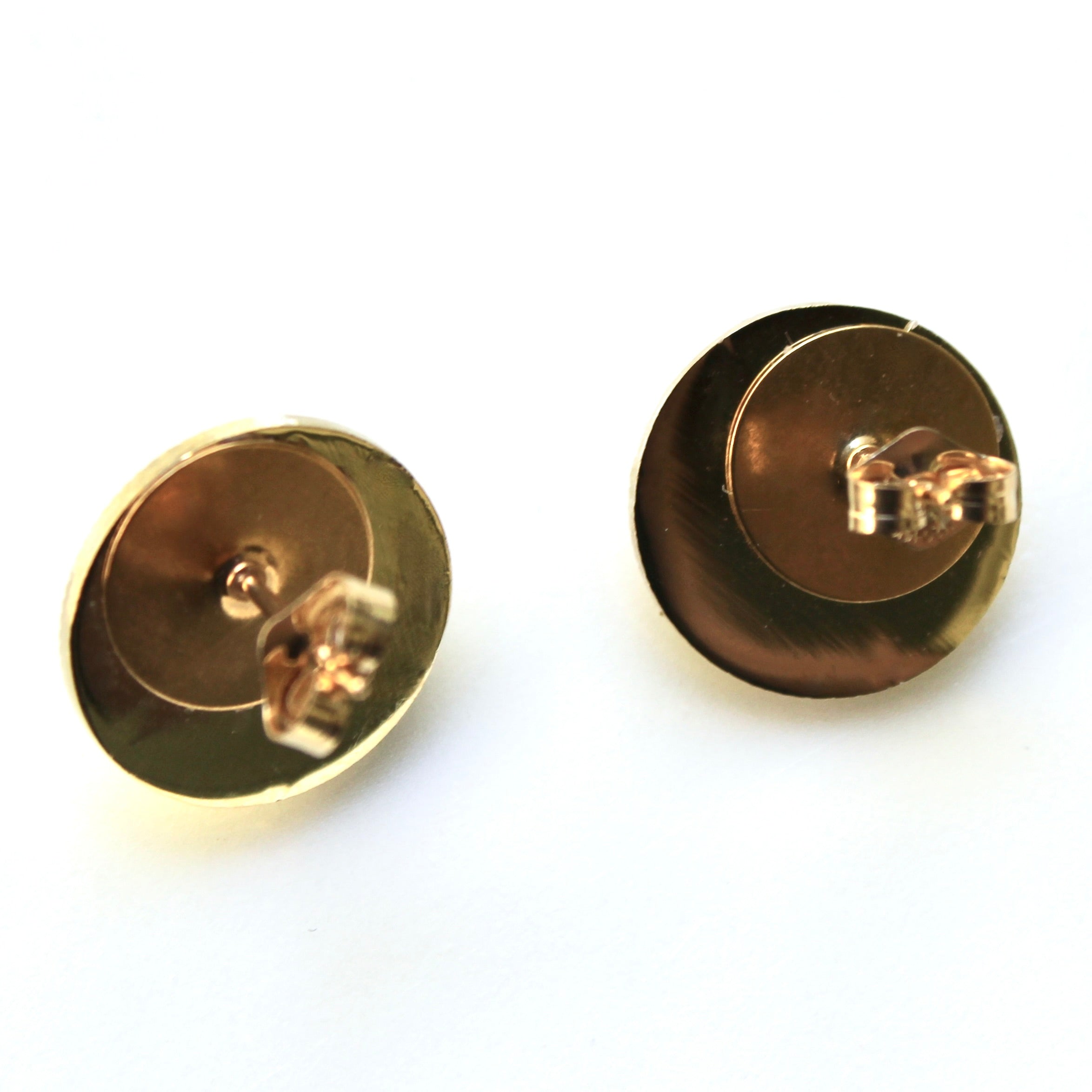 Pair of gold earrings on a white background