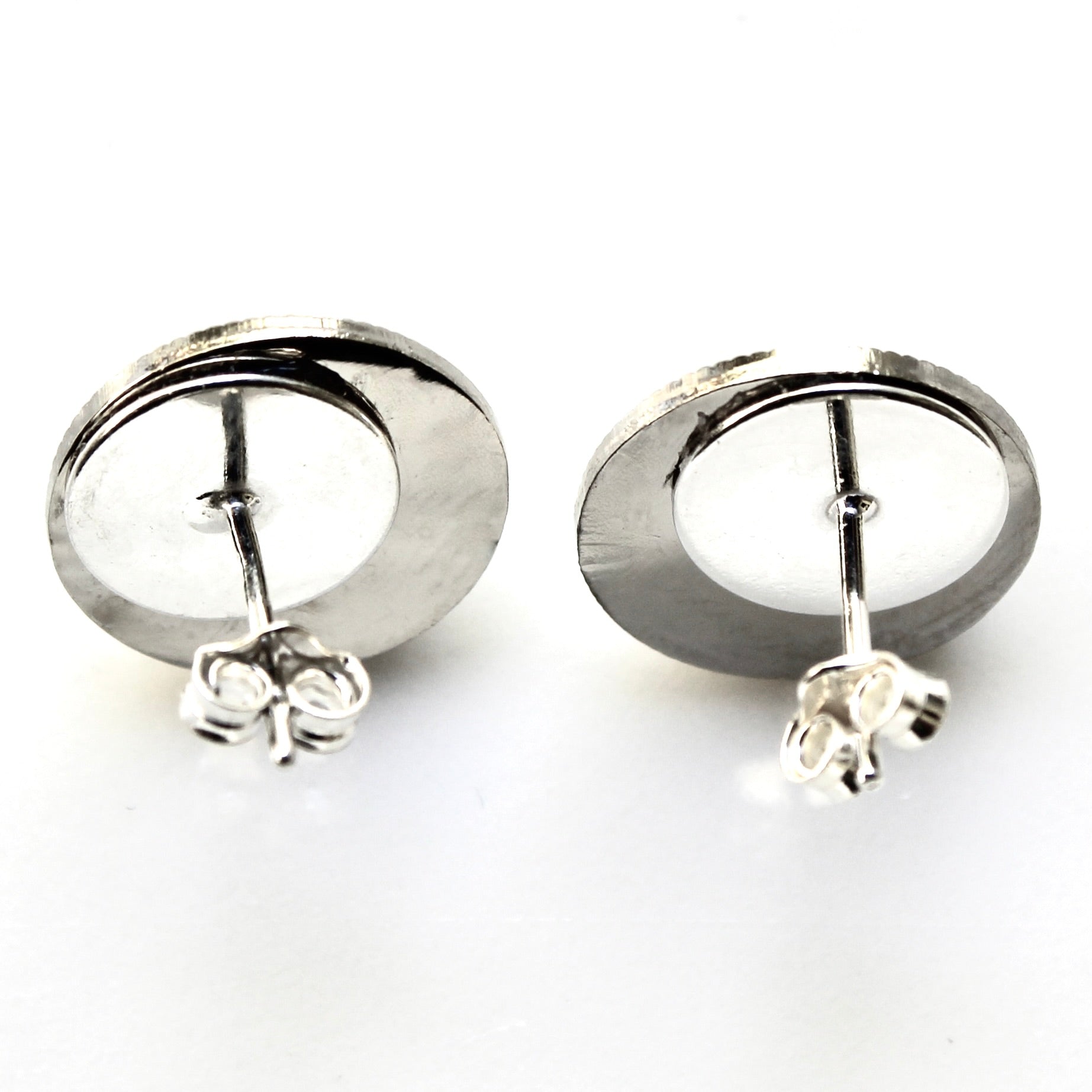 Pair of silver hoop earrings on a white background