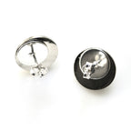 Silver earring with black back on a white background