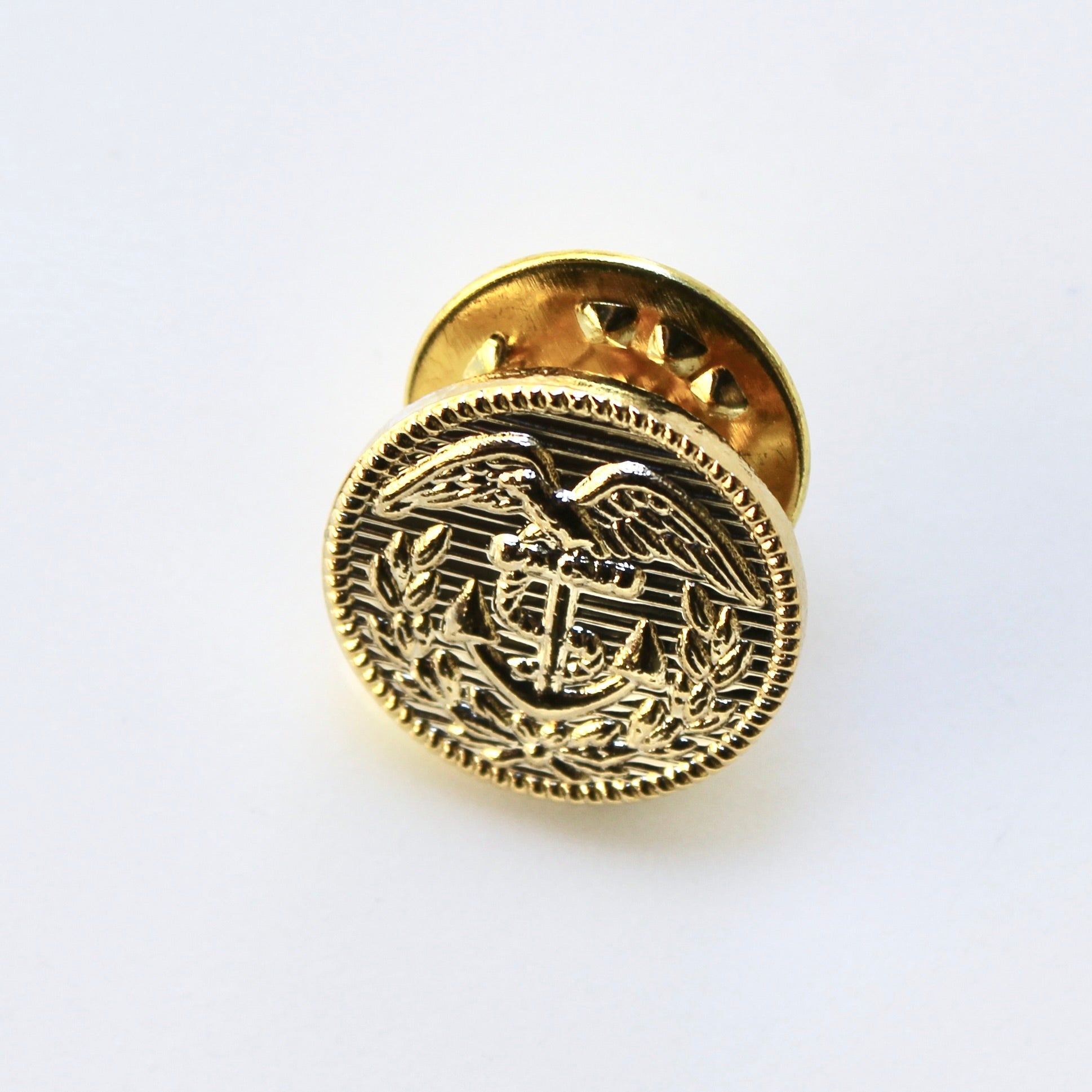 Gold emblematic badge on a white background