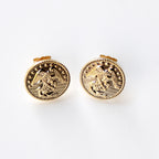 Gold circular earrings with an eagle design on a white background