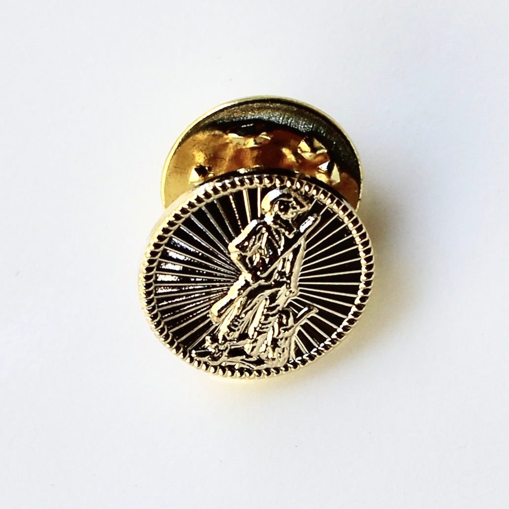 Gold emblem with a central figure on a white background