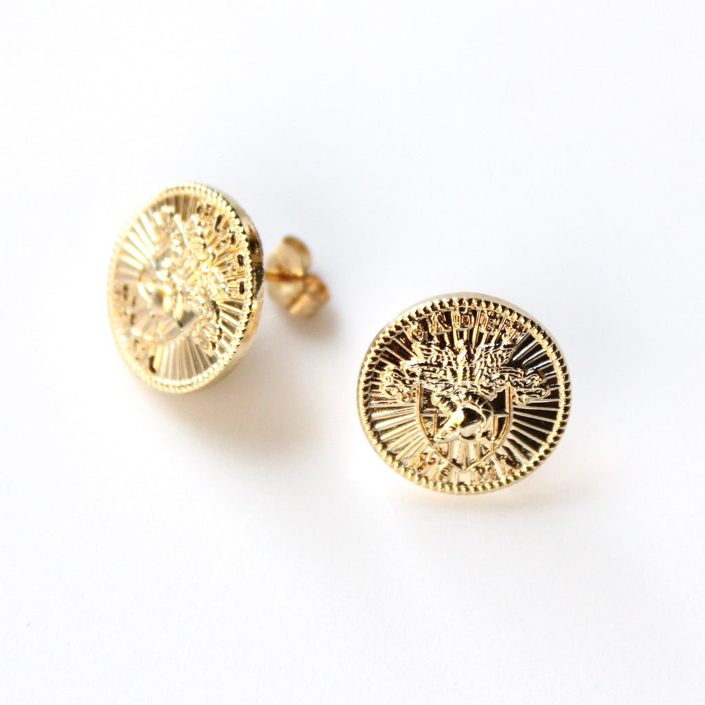 Gold circular earrings on a white background