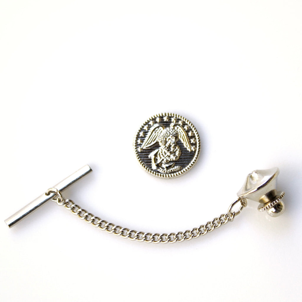 Silver tie pin with chain and angel design on a white background