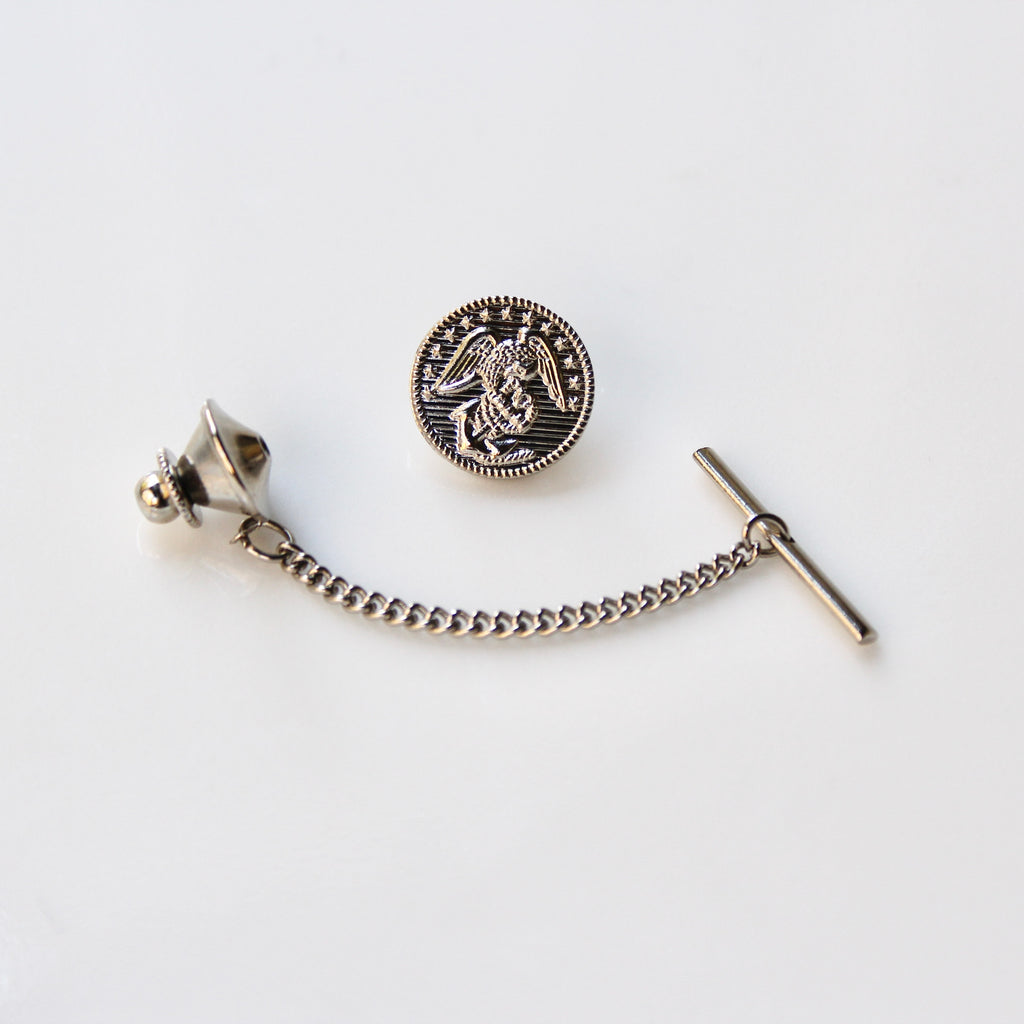 Silver tie pin with chain on a white background