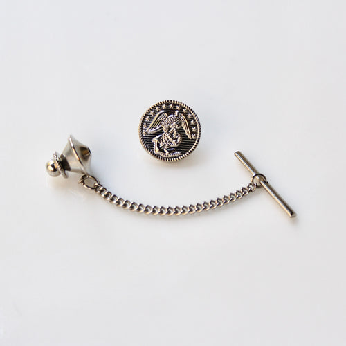 Silver tie pin with chain on a white background