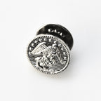 Silver metal button with eagle design on a white background