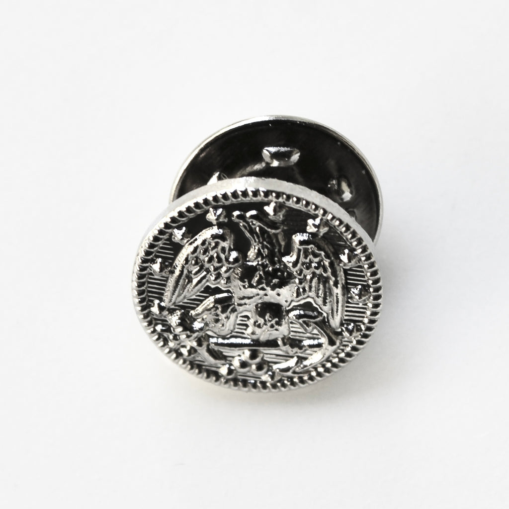 Silver emblematic button on a white background