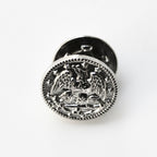 Silver emblematic button on a white background