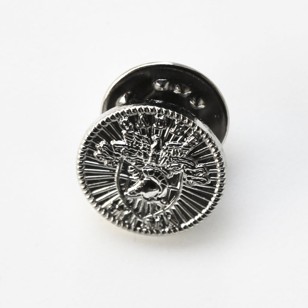 Metallic button with a deer emblem on a white background
