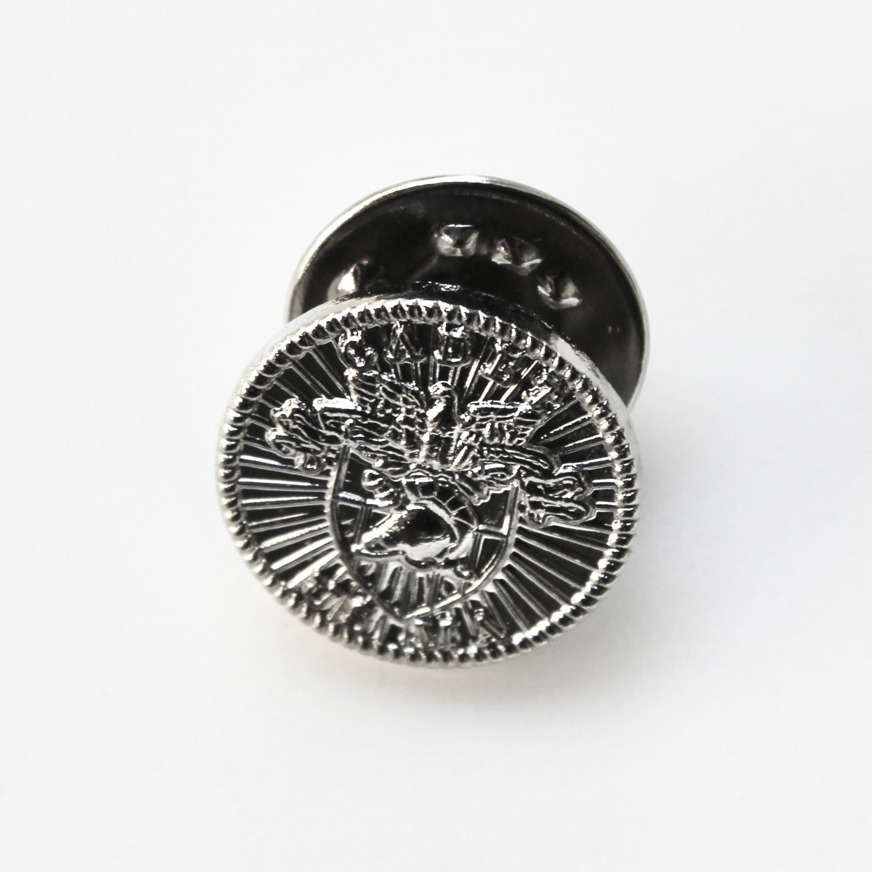Metallic button with a deer emblem on a white background