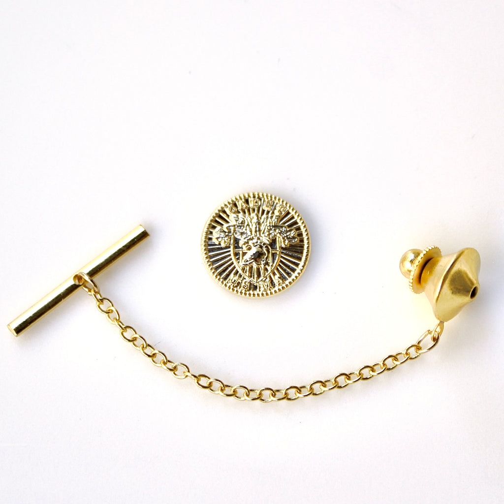 Gold tie pin with chain on a white background
