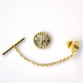 Gold tie pin with chain on a white background