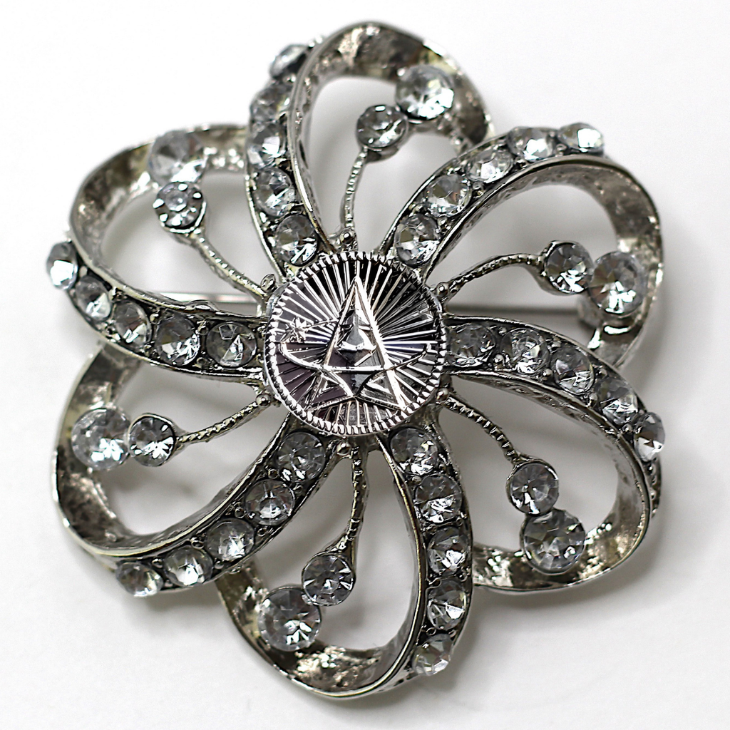 Silver flower-shaped brooch with clear gemstones and Space Force centerpiece on a white background