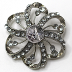 Silver flower-shaped brooch with clear gemstones and Space Force centerpiece on a white background