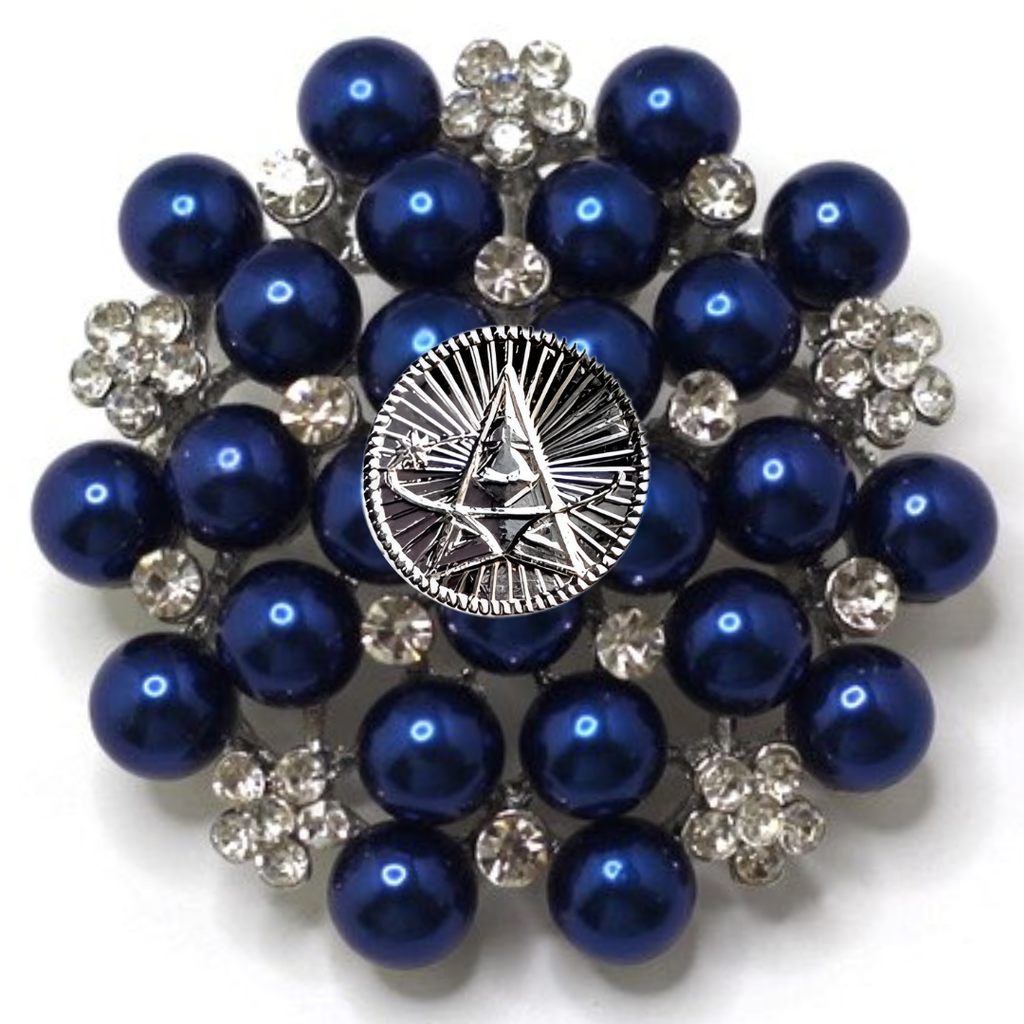 Brooch with blue pearls and silver accents on a white background