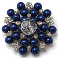 Brooch with blue pearls and silver accents on a white background