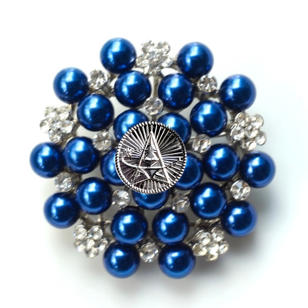 Blue pearl brooch with a central emblem on a white background