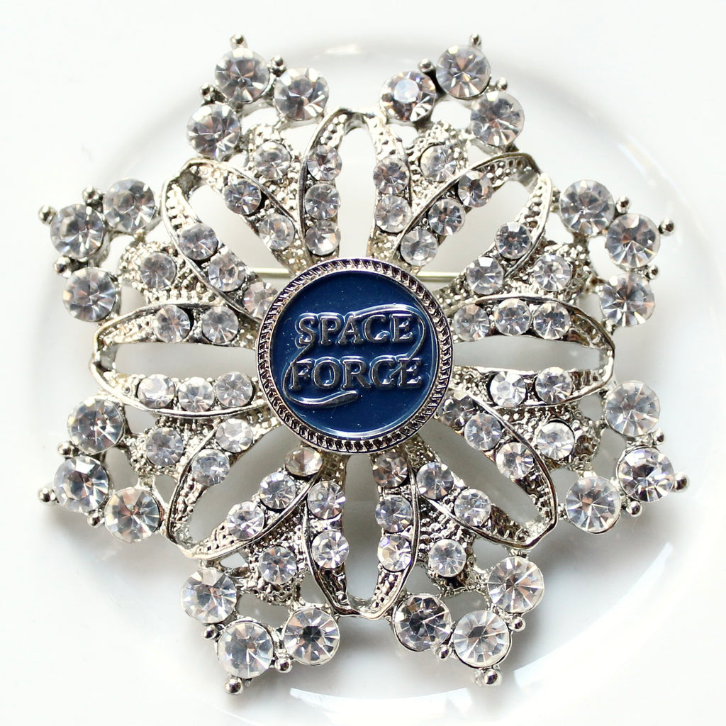 Decorative brooch with 'Space Force' emblem on a white background