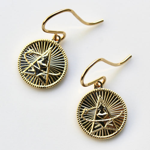 Gold earrings with intricate designs on a white background