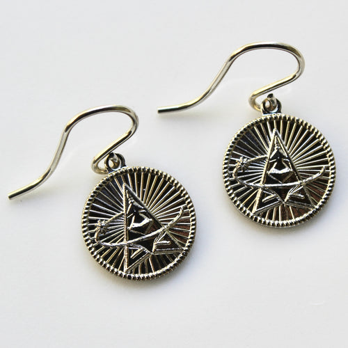 Silver earrings with geometric designs on a white background