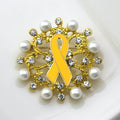 Brooch with yellow ribbon and pearl embellishments on a white background
