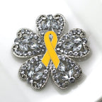 Brooch with a yellow ribbon and crystal-like design on a white background