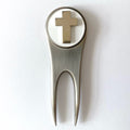 A silver golf divot tool with a magnetic ball marker featuring the U.S. Army Chaplain Corps Cross insignia.