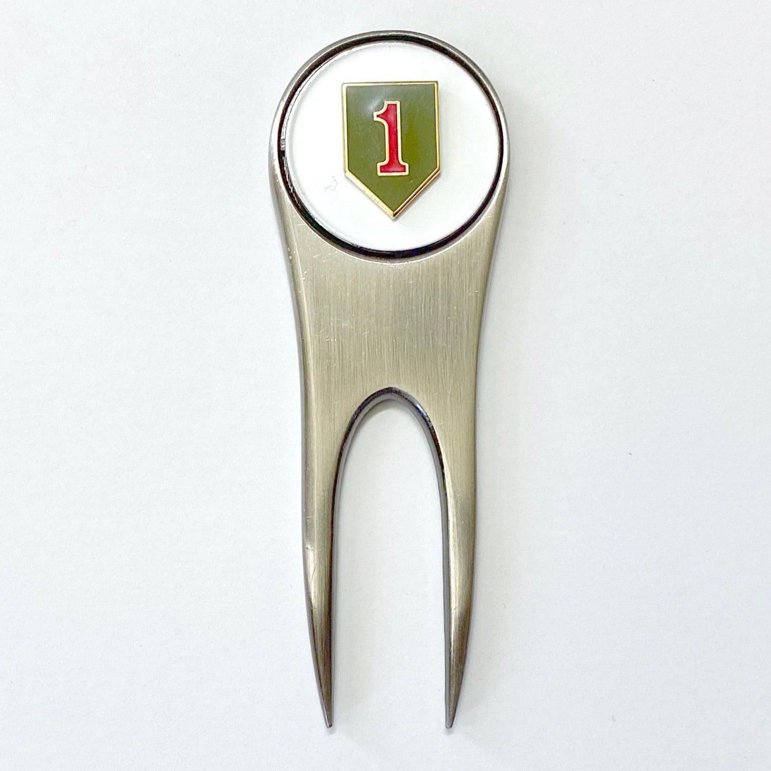 A silver golf divot tool with a magnetic ball marker featuring the 1st Infantry Division insignia.