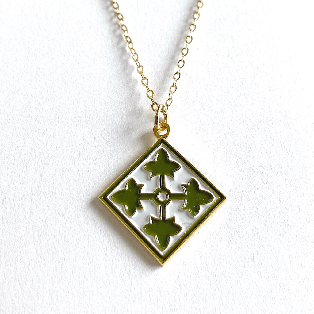 A gold-plated brass 4th Infantry Division charm necklace with a silver-tone steel chain.