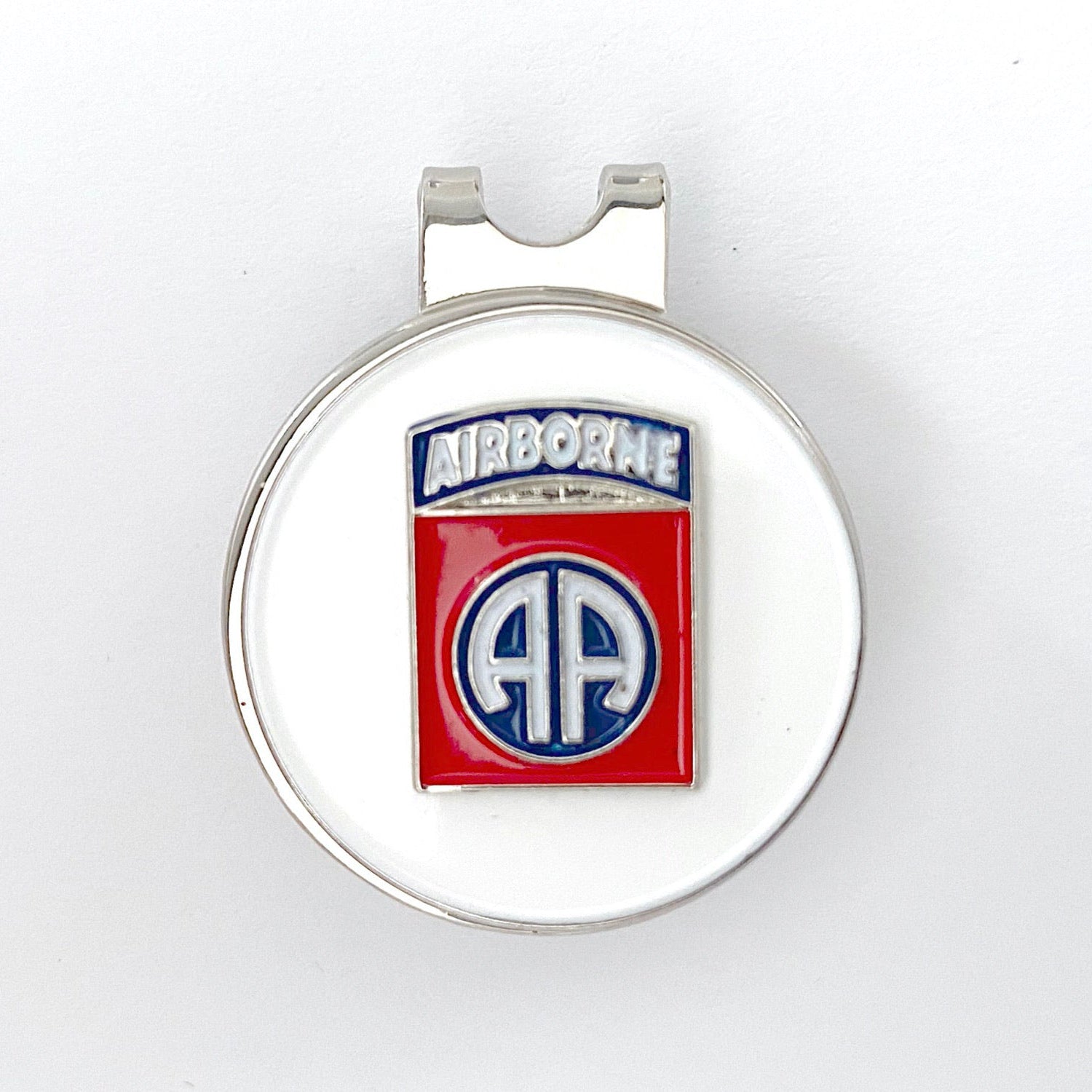 A round red, white, and blue golf hat clip with an 82nd Airborne Division centerpiece design.