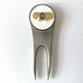 A silver golf divot tool with a magnetic ball marker featuring the U.S. Army Chemical Corps insignia centerpiece.