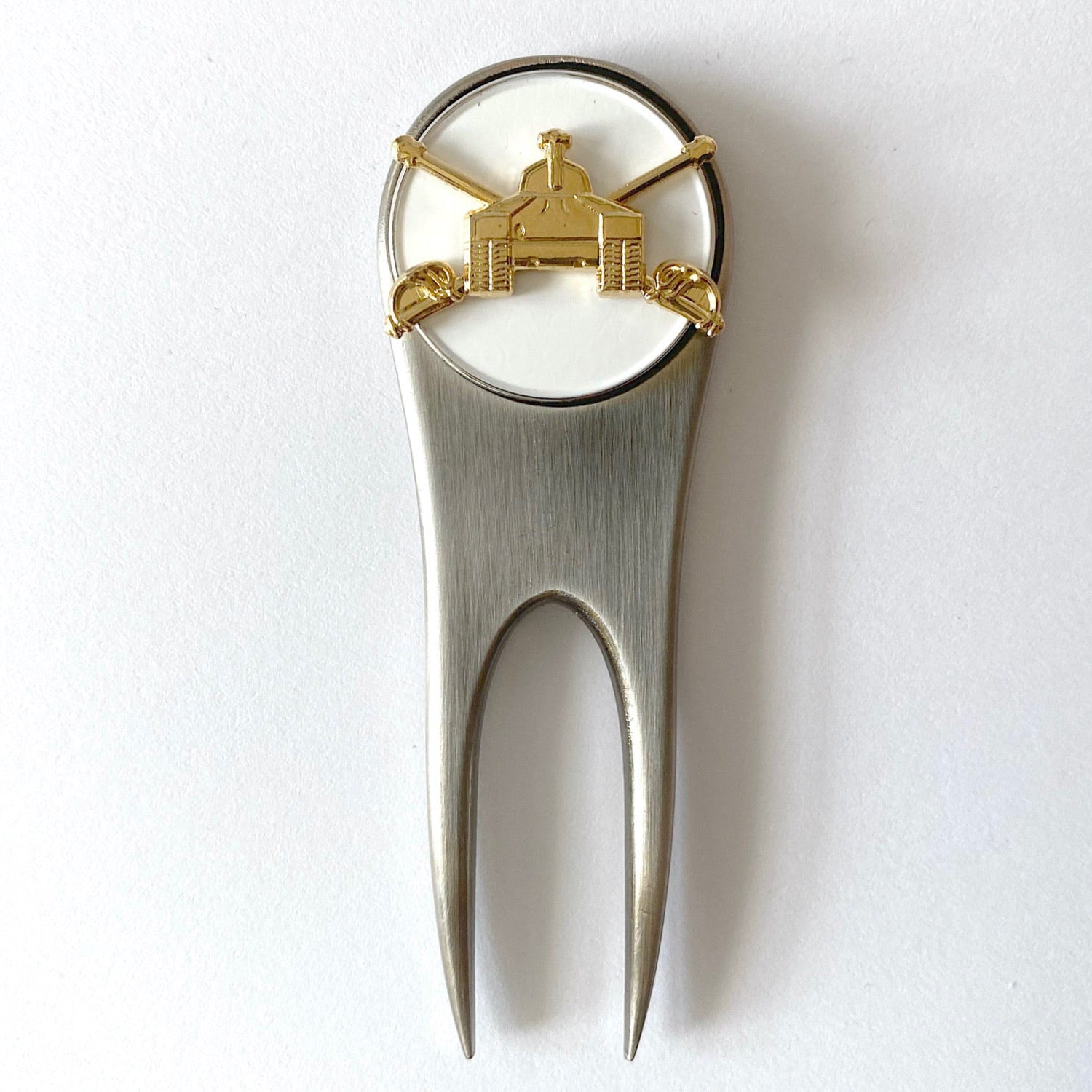 A silver golf divot tool with a magnetic ball marker featuring the U.S. Army Armor branch insignia centerpiece.