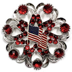 A round brooch featuring a American Flag centerpiece with red crystal rhinestones and silver accents.