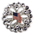 A round brooch featuring a American flag motif with crystal rhinestones.