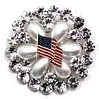 A round brooch featuring a American flag motif with crystal rhinestones.