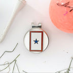 Golf ball marker with star design on a white surface