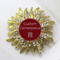A custom centerpiece brooch with a gold base and clear crystals, displaying a geometric pattern.