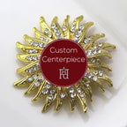 A custom centerpiece brooch with a gold base and clear crystals, displaying a geometric pattern.
