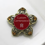 A gold brooch with topaz crystals and a custom centerpiece featuring military heraldry.