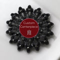 A black brooch with black crystals, featuring a central emblem and the text 'Custom Centerpiece Hope Design Ltd.'