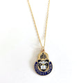 A gold-colored Chaplain Corps charm necklace with a blue and white enamel detail, displayed on a white background.