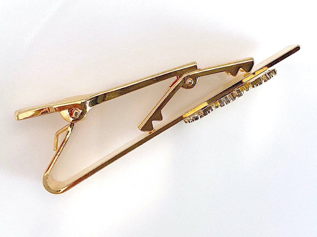 Top view of gold tie bar clip