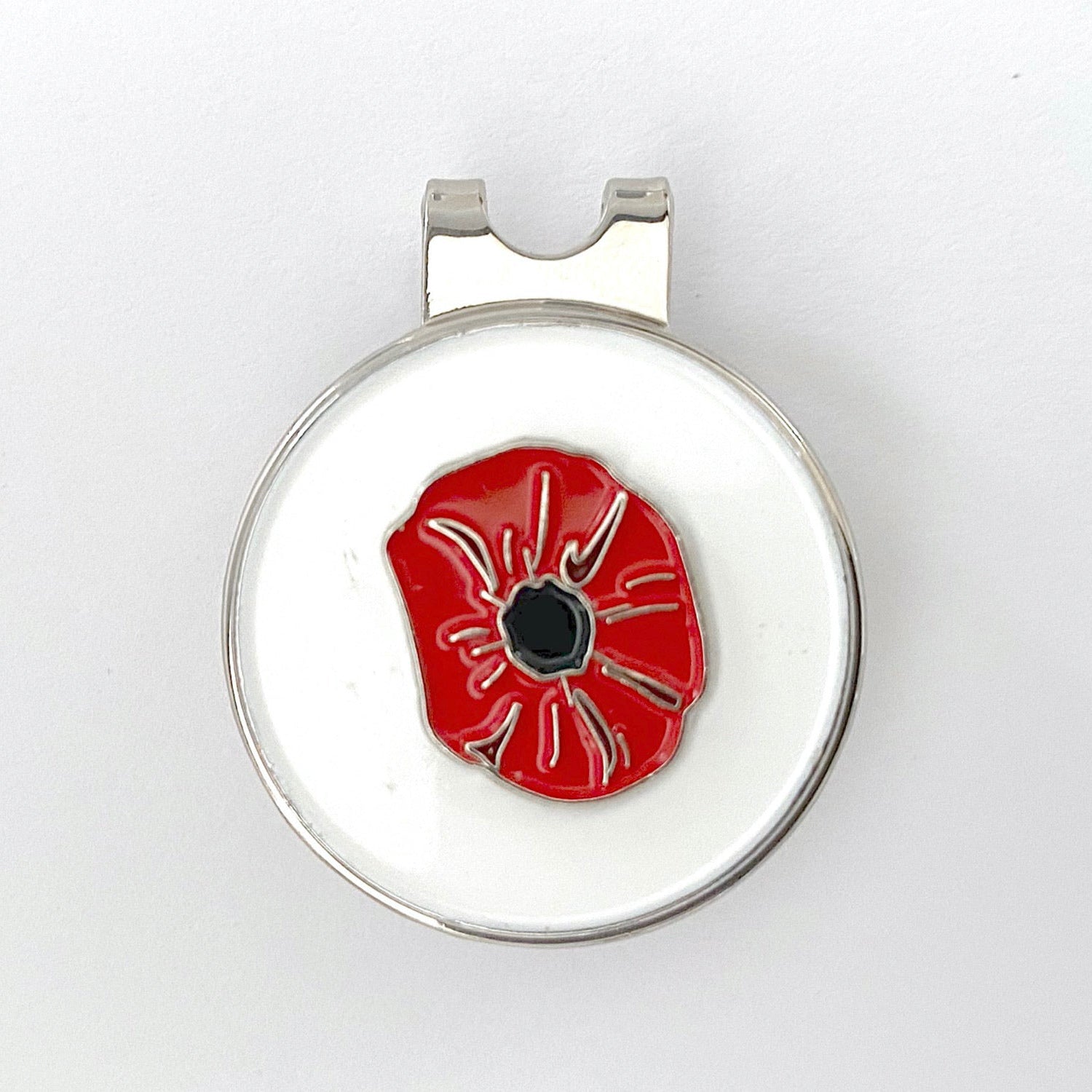 A golf hat clip with a magnetic ball marker featuring a red poppy flower design.