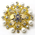 A gold-colored brooch with a U.S. Army Chemical Corps insignia centerpiece, adorned with white pearls and clear crystals.