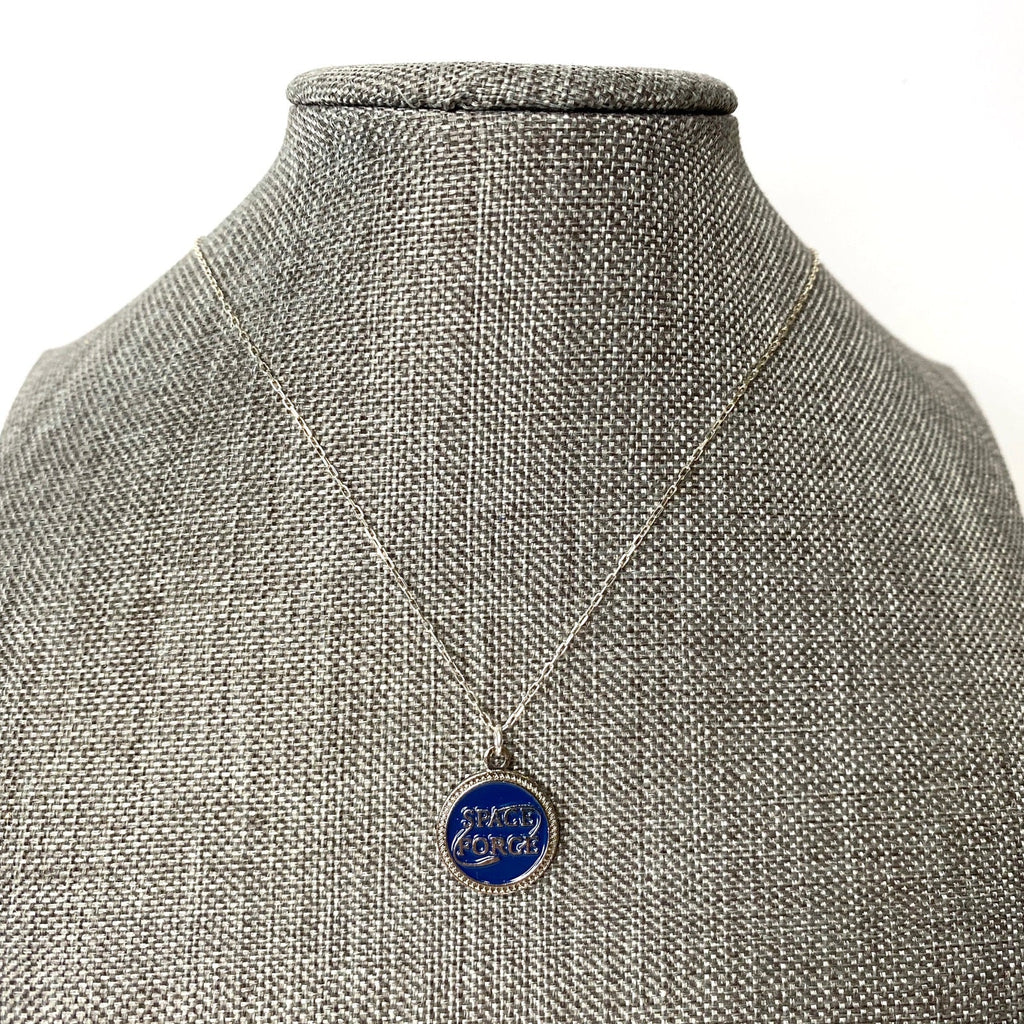 Necklace with a blue pendant on a mannequin
