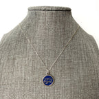 Necklace with a blue pendant on a mannequin