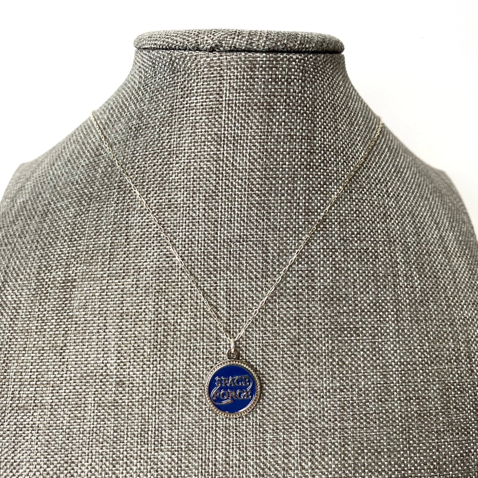 Necklace with a blue pendant on a mannequin